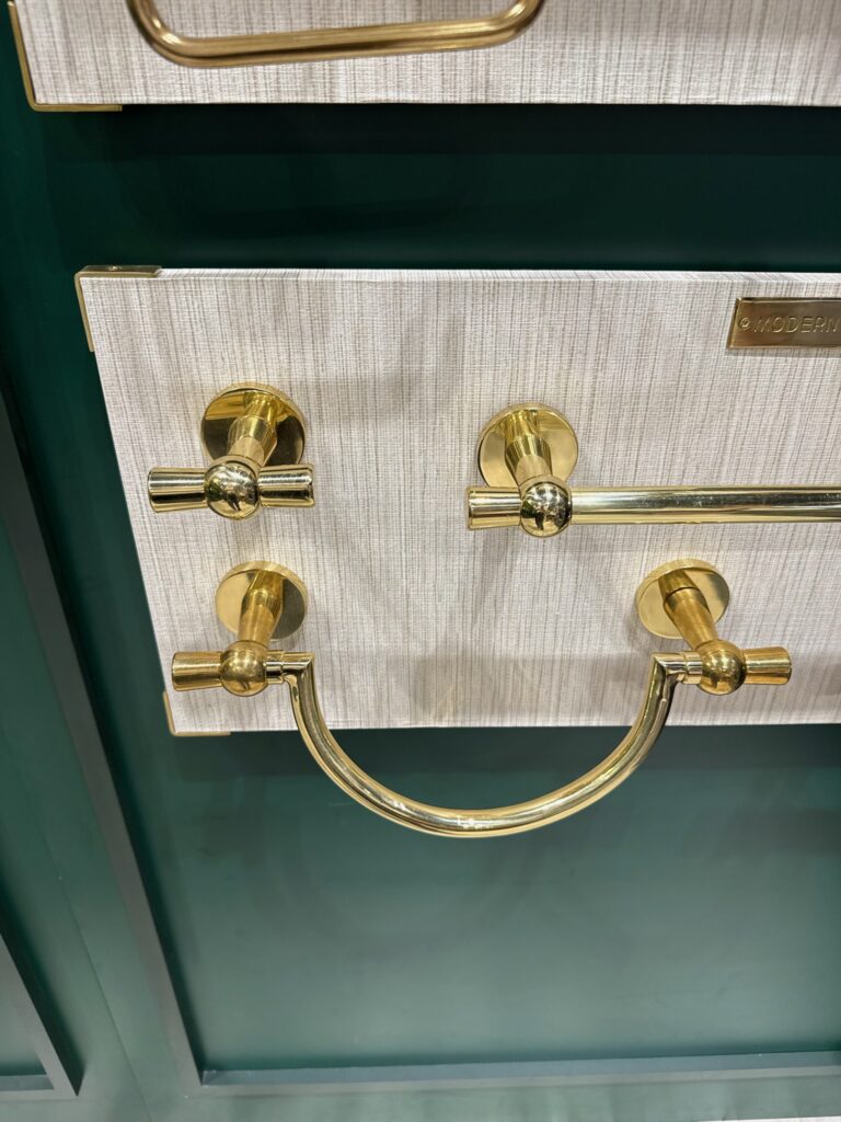 Modern Matter gold tone brass bathroom hardware. Brass U shaped towel bar. Brass straight towel bar with rounded back plates, and one brass double hook for a wall to hang towels or robes. 